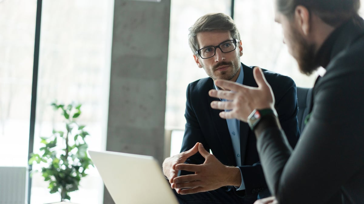 Business partners discussing a deal in a modern office